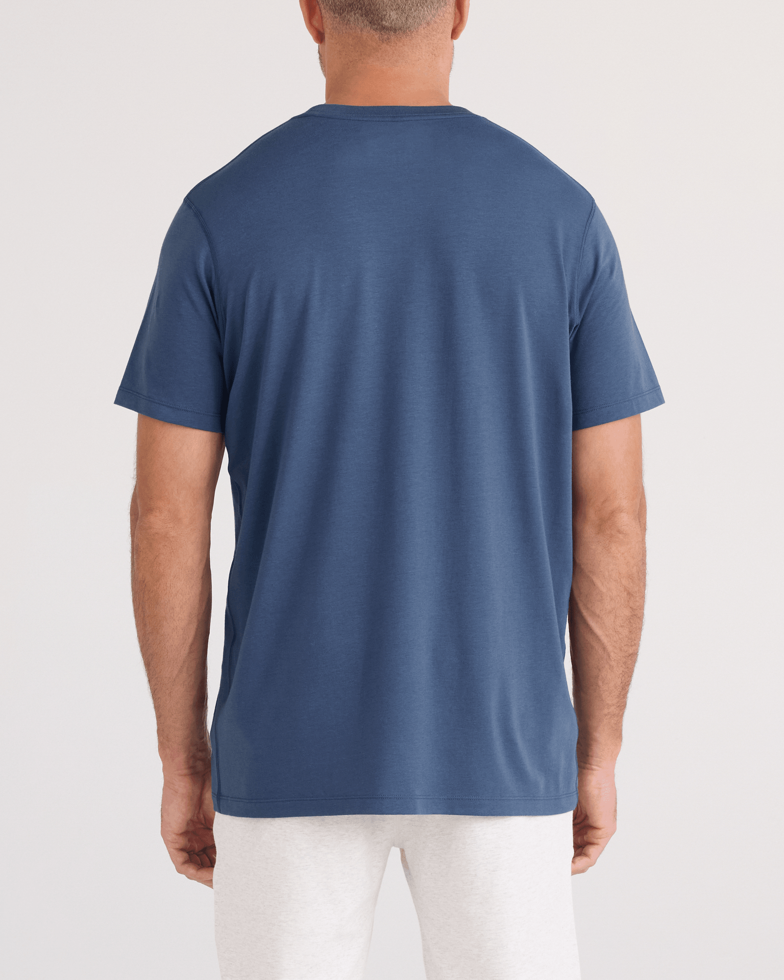 Back - Model wearing DropTemp Cooling Cotton Tee in Washed Indigo