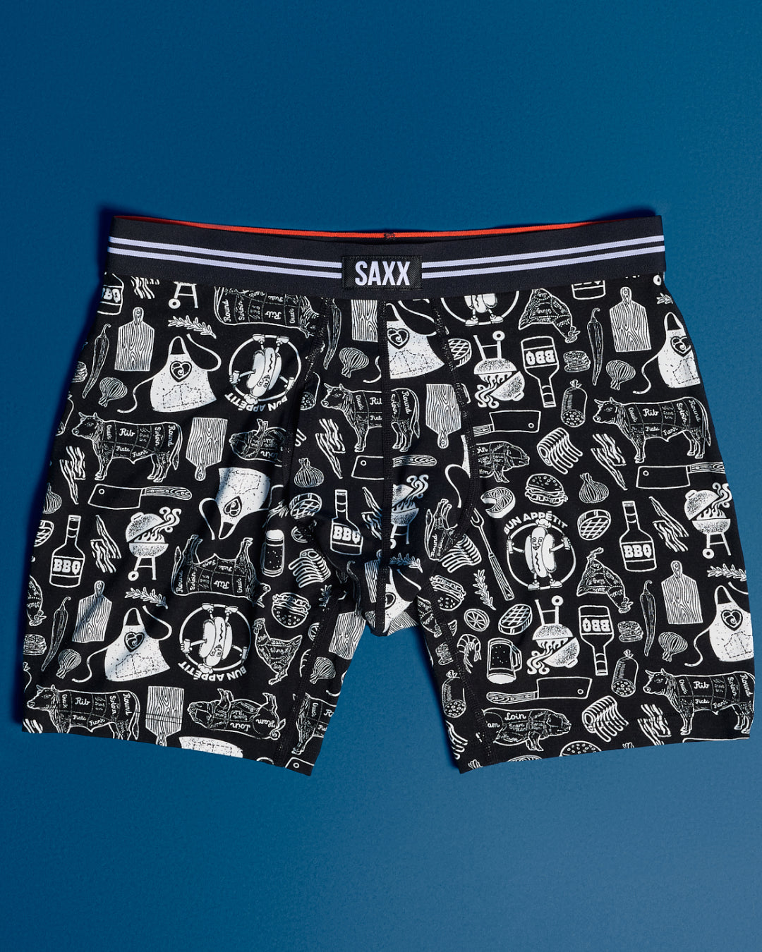 Black boxer briefs with white graphic design on a blue background, featuring the brand 'SAXX'.