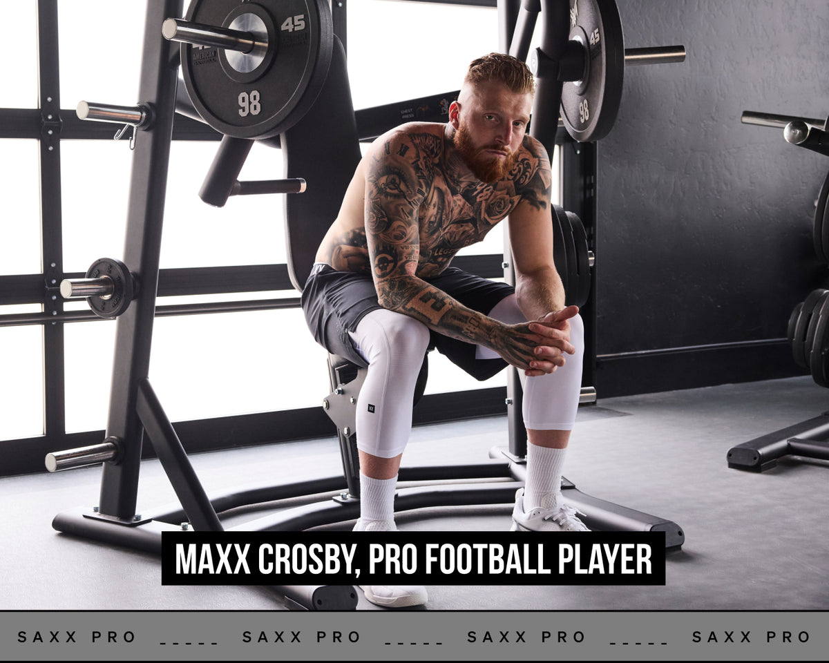 Pro Football Player Maxx Crosby poses in SAXX performance clothnig in a gym