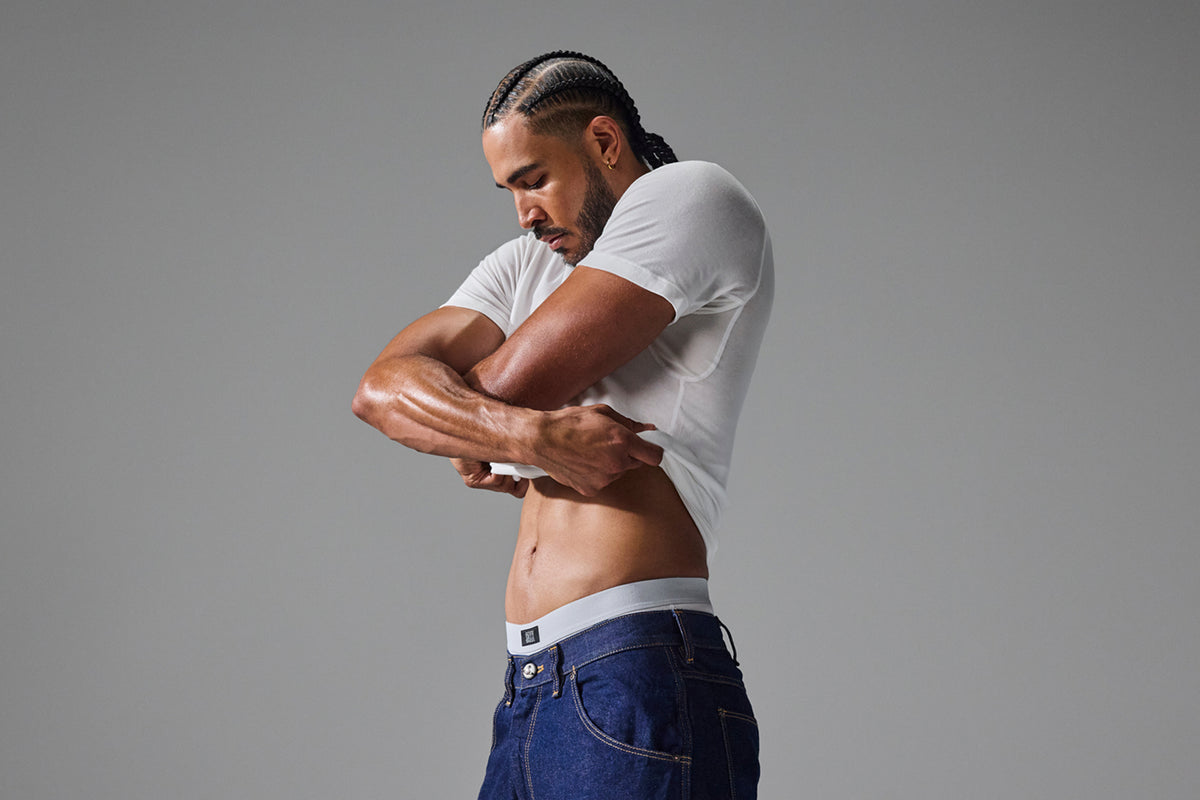 Model putting on a SAXX Undershirt