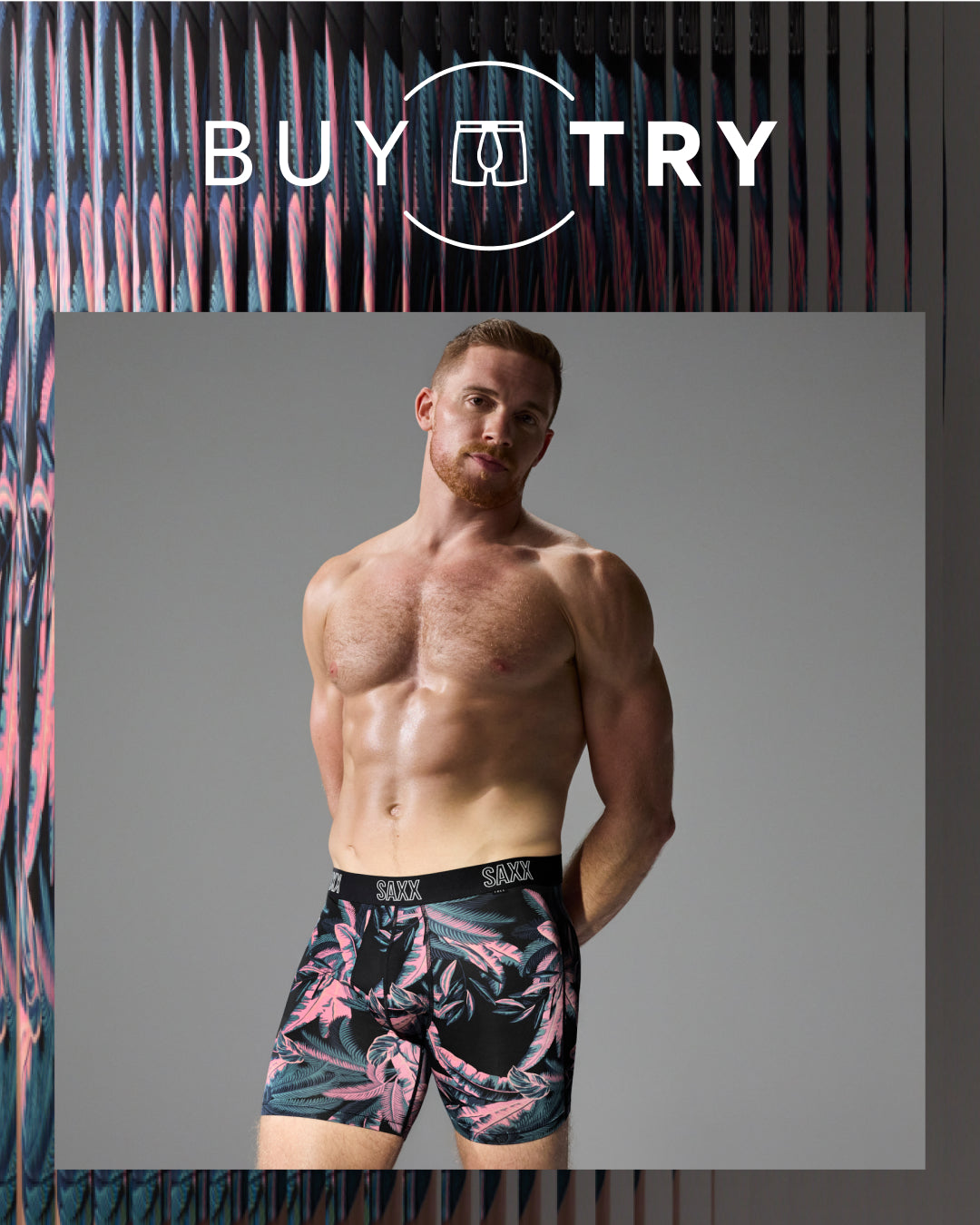 A shirtless male model wearing patterned boxer briefs with a black, pink, and gray tropical print, set against a gray background with a 'BUY TRY' graphic overlay at the top.
