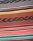 Close-up of a fabric with colorful stripes and a brand name.