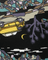 Colorful fabric pattern with a yellow vehicle, moon, and abstract shapes.